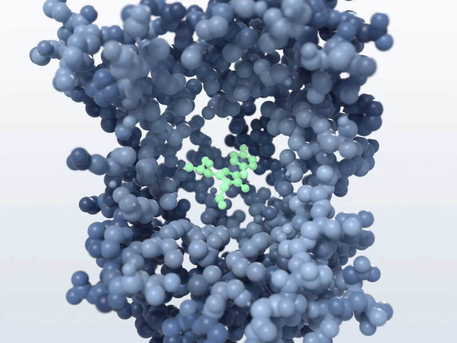 A cone cut into a sphere model of GFP reveals the green chromophore in ball-and-stick inside.